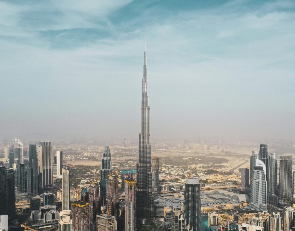 A breathtaking aerial view of Dubai's skyline featuring Burj Khalifa amidst modern skyscrapers under a clear sky.