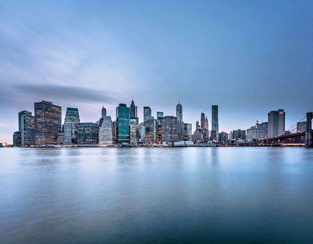 Stunning view of the New York City skyline and Brooklyn Bridge at dusk.