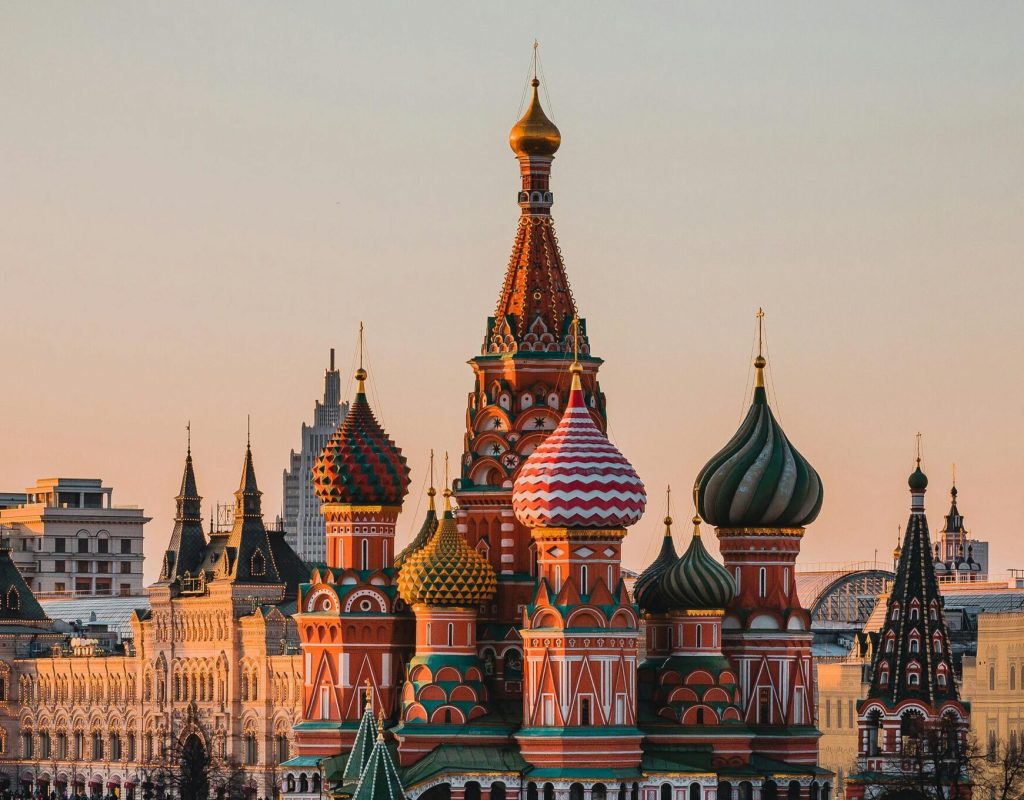 Stunning view of St. Basil's Cathedral in Moscow during sunset with a bustling crowd.