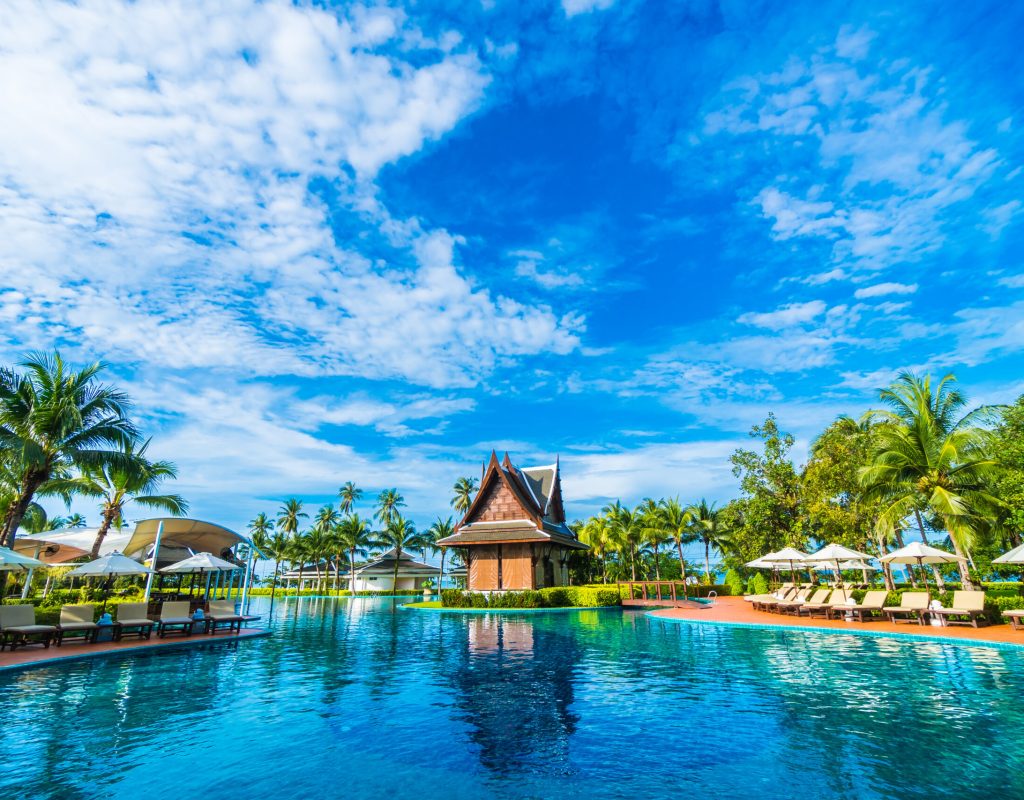 umbrella and chair around swimming pool